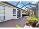 Enclosed patio featuring stained concrete, glass roof, and outdoor dining area with barbeque and comfortable seating at 1498 Truval Ter, Port Charlotte, FL 33952
