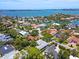 Wide-angle aerial showcases waterfront houses and community surrounded by trees and access to the bay at 1541 Flower Dr, Sarasota, FL 34239