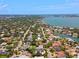 Extensive aerial perspective features community homes, verdant trees, and a waterfront area with access to the bay at 1541 Flower Dr, Sarasota, FL 34239