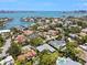 An aerial view displays homes nestled amidst lush greenery in a waterfront community with access to the bay at 1541 Flower Dr, Sarasota, FL 34239