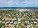 An aerial perspective reveals a single-story home surrounded by manicured lawns and mature trees at 1541 Flower Dr, Sarasota, FL 34239