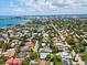 An aerial view shows a single-story home nestled in a neighborhood of lush, mature trees and greenery at 1541 Flower Dr, Sarasota, FL 34239