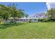 Expansive backyard featuring lush lawn, mature trees, and plenty of space for recreation at 1541 Flower Dr, Sarasota, FL 34239