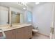 Bathroom featuring neutral tile, a large vanity, a toilet, and a shower with glass door and white curtain at 1541 Flower Dr, Sarasota, FL 34239