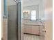 Traditional bathroom with glass shower, patterned tile floor, and vanity with ample cabinet space at 1541 Flower Dr, Sarasota, FL 34239