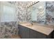 Bathroom featuring a vanity with ample storage and a large, framed mirror at 1541 Flower Dr, Sarasota, FL 34239