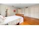 Bedroom showcasing hardwood floors, striped wallpaper, and closet organizers at 1541 Flower Dr, Sarasota, FL 34239