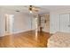 Spacious bedroom with hardwood floors, a ceiling fan, closet, and built-in shelving/desk area at 1541 Flower Dr, Sarasota, FL 34239