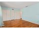 Bedroom boasts hardwood floors, large closet space, and serene blue walls at 1541 Flower Dr, Sarasota, FL 34239