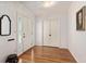 Bright foyer featuring polished hardwood floors, a stylish mirror, and a classic chandelier at 1541 Flower Dr, Sarasota, FL 34239