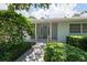 Home's entrance featuring a light blue door, white trim and complementary green landscaping at 1541 Flower Dr, Sarasota, FL 34239