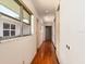 Long hallway with hardwood floors, natural lighting from large windows, and built-in storage at 1541 Flower Dr, Sarasota, FL 34239
