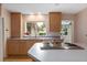 Kitchen with a center island cooktop, stainless steel sink and an open design at 1541 Flower Dr, Sarasota, FL 34239