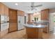 This kitchen includes a cooktop island, light wood cabinets, and stainless steel appliances at 1541 Flower Dr, Sarasota, FL 34239
