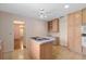 Kitchen with an island cooktop, light wood cabinets, and durable flooring at 1541 Flower Dr, Sarasota, FL 34239