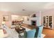 Cozy living room features a fireplace, hardwood floors and is open to the dining room at 1541 Flower Dr, Sarasota, FL 34239