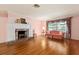 The living room boasts hardwood floors, a fireplace, and plenty of natural light at 1541 Flower Dr, Sarasota, FL 34239