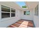 Enclosed patio area with neutral-colored wall, skylight and colorful striped rug at 1541 Flower Dr, Sarasota, FL 34239