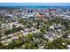 Stunning aerial view of a neighborhood with mature trees and city skyline in the background at 1732 6Th St, Sarasota, FL 34236