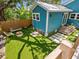 Private backyard featuring artificial grass, outdoor seating, and a fenced perimeter at 1732 6Th St, Sarasota, FL 34236