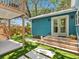 Charming turquoise home with a lovely backyard featuring stepping stones and a second story porch at 1732 6Th St, Sarasota, FL 34236