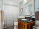 Bathroom featuring a marble countertop, a glass shower door, and a white shower curtain at 1732 6Th St, Sarasota, FL 34236