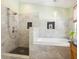 Modern bathroom features a marble tiled shower and tub, stylish fixtures, and a hanging pendant light at 1732 6Th St, Sarasota, FL 34236