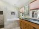 Bright bathroom features marble tile, stylish fixtures, a double sink vanity, and a large mirror at 1732 6Th St, Sarasota, FL 34236