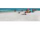 Wide panoramic beach view with beachgoers enjoying the sand and surf on a sunny day at 1732 6Th St, Sarasota, FL 34236