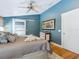 A cozy bedroom features blue walls, hardwood floors, and a sliding barn door at 1732 6Th St, Sarasota, FL 34236