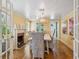 Cozy dining room featuring a fireplace, hardwood floors, and a wicker dining set at 1732 6Th St, Sarasota, FL 34236