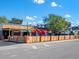 Outdoor restaurant seating area with umbrellas and a wooden fence at 1732 6Th St, Sarasota, FL 34236