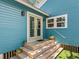 Charming exterior entrance with wooden steps and blue painted siding at 1732 6Th St, Sarasota, FL 34236