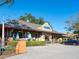 Exterior of building with covered patio seating, surrounded by green plants at 1732 6Th St, Sarasota, FL 34236
