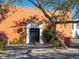 Exterior of building entrance with orange walls and dark doors and 'Oasis' etched above entrance at 1732 6Th St, Sarasota, FL 34236