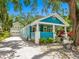 Attractive blue bungalow with a welcoming front porch and landscaped surroundings at 1732 6Th St, Sarasota, FL 34236