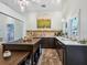 Bright kitchen with a dark wood island, cabinets, a tile floor, and modern appliances at 1732 6Th St, Sarasota, FL 34236