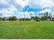 View of empty lot with green grass and nearby buildings in the background at 1732 6Th St, Sarasota, FL 34236