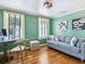 Stylish living room features hardwood floors, a comfortable couch, and bright natural light from the windows at 1732 6Th St, Sarasota, FL 34236