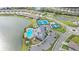 Aerial view showcases the community clubhouse, pool, pickleball courts, putting green, and winding lakes at 17320 Polo Trl, Bradenton, FL 34211
