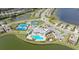 Aerial view of community clubhouse, pool, tennis courts, and lakes at 17320 Polo Trl, Bradenton, FL 34211
