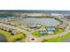 Aerial view of a community with lakes, a clubhouse, and tennis courts offering a recreational and luxurious lifestyle at 17320 Polo Trl, Bradenton, FL 34211
