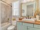 Bathroom with a shower and tub, single sink vanity with wood countertop, and shiplap walls at 17320 Polo Trl, Bradenton, FL 34211