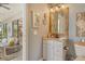 Well-lit bathroom with granite vanity, decorated with nautical themed art, and exterior patio access at 17320 Polo Trl, Bradenton, FL 34211