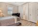 Cozy bedroom featuring a bed, desk setup with monitors, and a view to the ensuite bathroom at 17320 Polo Trl, Bradenton, FL 34211