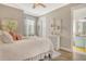 Serene bedroom with soft pink accents, a comfortable bed and a dresser adjacent to an ensuite bathroom at 17320 Polo Trl, Bradenton, FL 34211