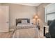 Bedroom with hardwood floors, neutral walls, a bed with a patterned blanket, and a corner desk at 17320 Polo Trl, Bradenton, FL 34211