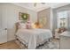 Comfortable bedroom with white wood paneled walls, a plush bed and vintage-inspired decor at 17320 Polo Trl, Bradenton, FL 34211