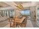 Elegant dining room featuring wood table, unique lighting fixture and sliding glass doors to a patio with lake views at 17320 Polo Trl, Bradenton, FL 34211