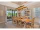 Dining room with access to the outdoor entertaining space and views of the lake at 17320 Polo Trl, Bradenton, FL 34211